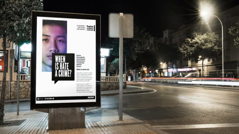 Our work: Public service announcement Adshell billboard on a city street at night asking ‘WHEN IS HATE A CRIME?’ with a website ‘hatecrime.com.au’ listed for information and support.